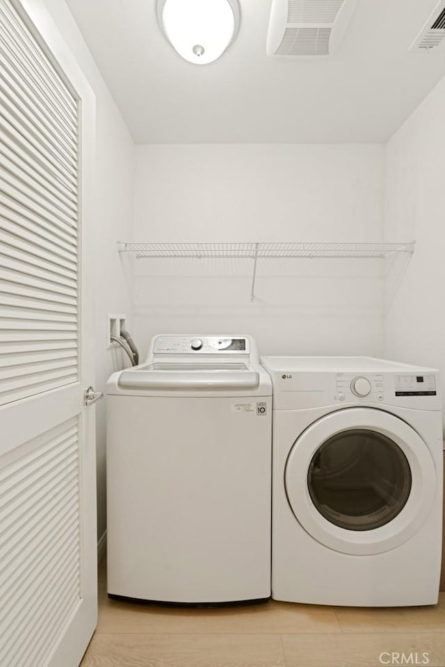 laundry room featuring washing machine and clothes dryer