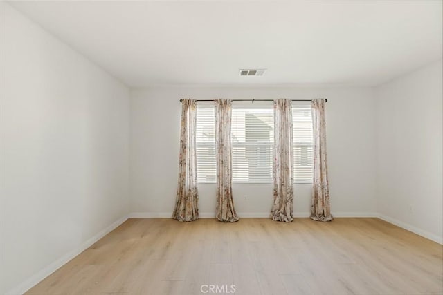 spare room with light wood-type flooring