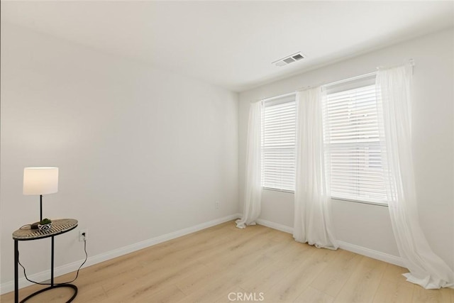 spare room featuring light hardwood / wood-style flooring