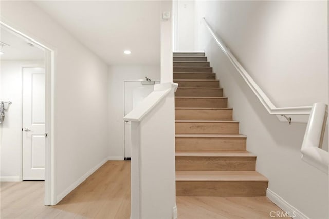 staircase featuring hardwood / wood-style flooring