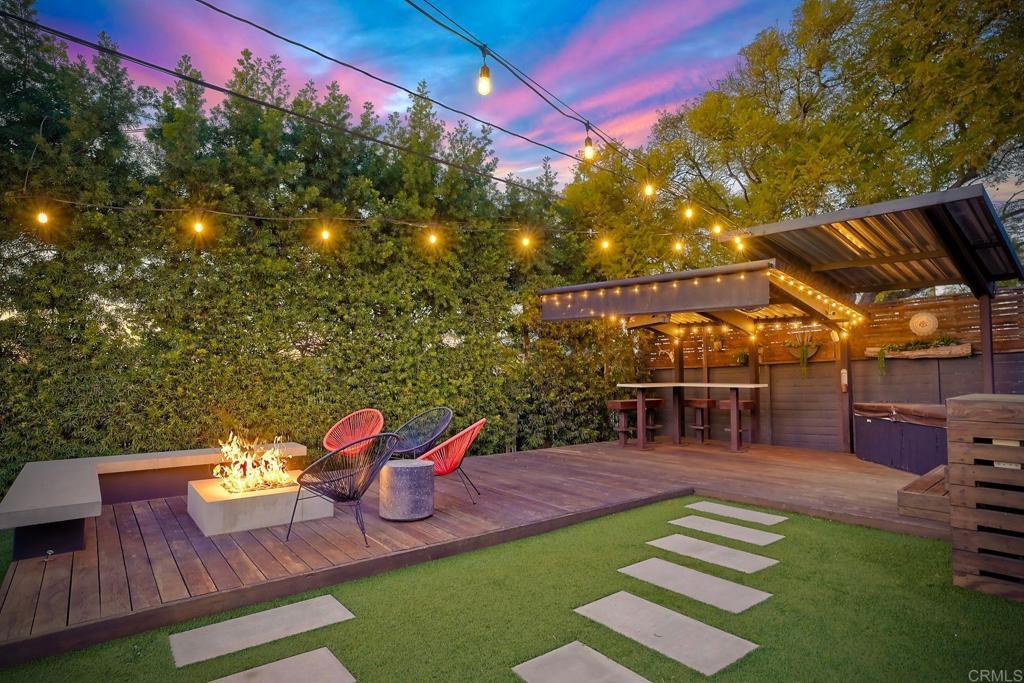 yard at dusk featuring an outdoor fire pit and a wooden deck