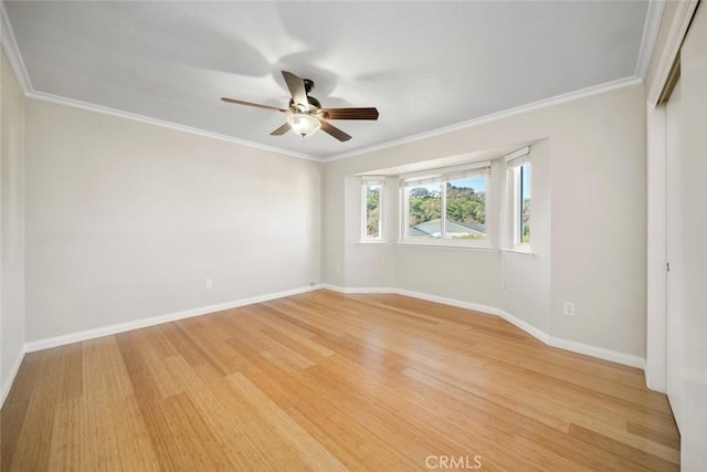 empty room with ornamental molding, ceiling fan, and light hardwood / wood-style floors