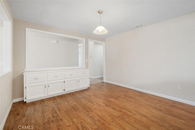 unfurnished room with light hardwood / wood-style floors