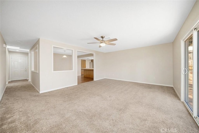 unfurnished room with light colored carpet and ceiling fan