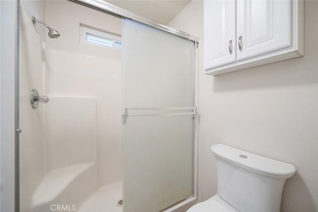 bathroom with toilet and walk in shower