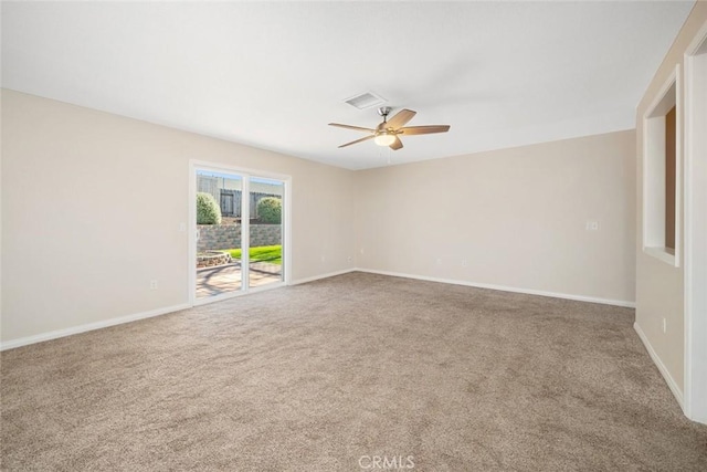 carpeted spare room with ceiling fan