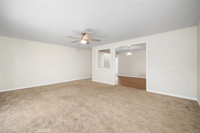 carpeted spare room with ceiling fan