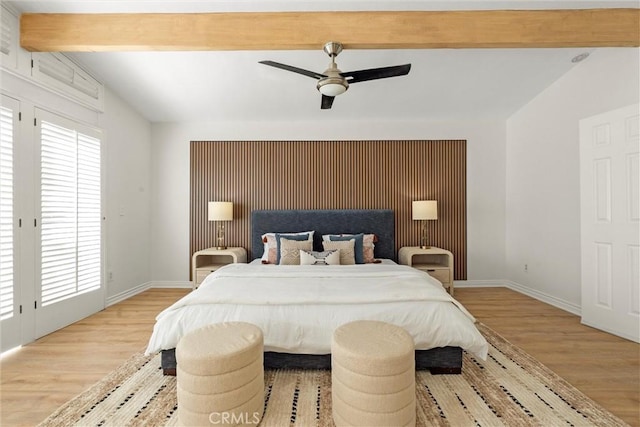 bedroom featuring light hardwood / wood-style floors, ceiling fan, and lofted ceiling with beams