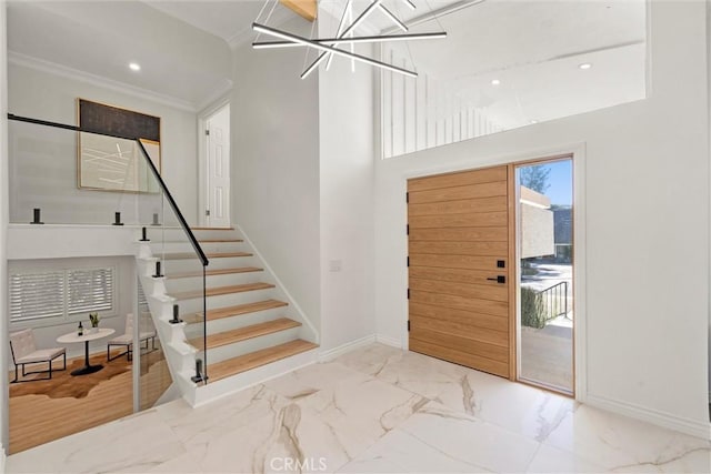 entrance foyer with a high ceiling and crown molding