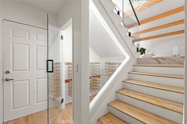 stairs featuring hardwood / wood-style floors