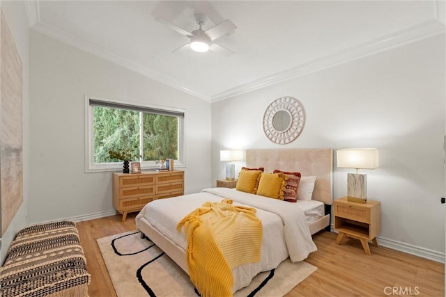 bedroom with light hardwood / wood-style floors, ceiling fan, lofted ceiling, and crown molding