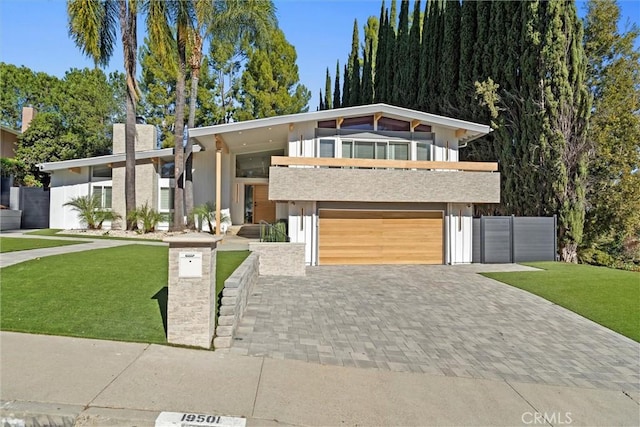 modern home with a front lawn and a garage