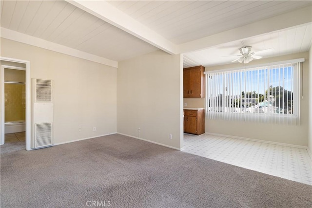 spare room with light colored carpet, ceiling fan, and beamed ceiling