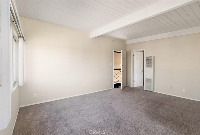 unfurnished bedroom featuring multiple windows, carpet, and beamed ceiling