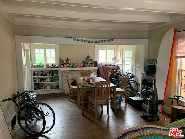 dining room with beamed ceiling and hardwood / wood-style floors