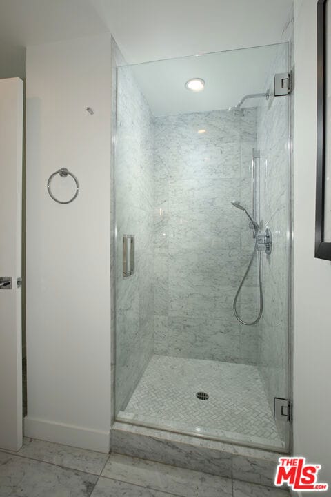 bathroom featuring a shower with door