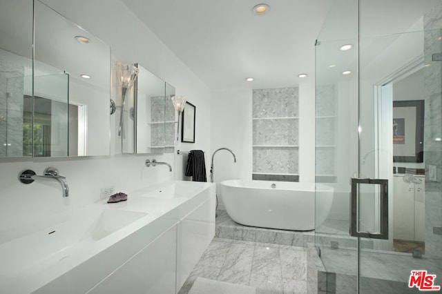 bathroom with vanity and independent shower and bath