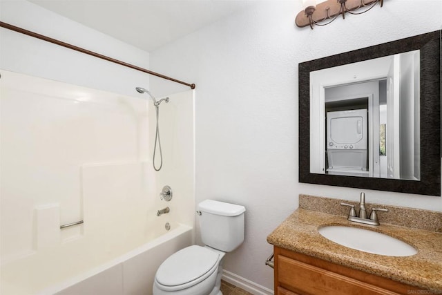 full bathroom with toilet, stacked washer and clothes dryer, vanity, and bathtub / shower combination