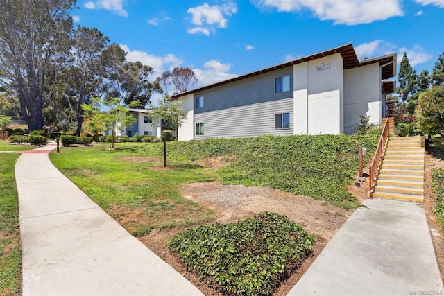 view of side of home with a lawn