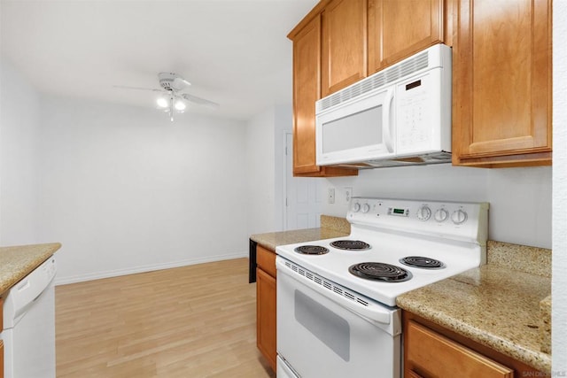 kitchen featuring light stone countertops, white appliances, ceiling fan, and light hardwood / wood-style flooring