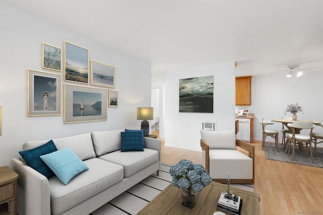 living room with light hardwood / wood-style floors and ceiling fan