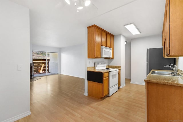 kitchen with white appliances, ceiling fan, light hardwood / wood-style floors, and sink