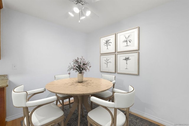 dining space with hardwood / wood-style flooring