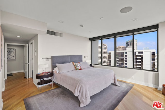 bedroom with hardwood / wood-style floors