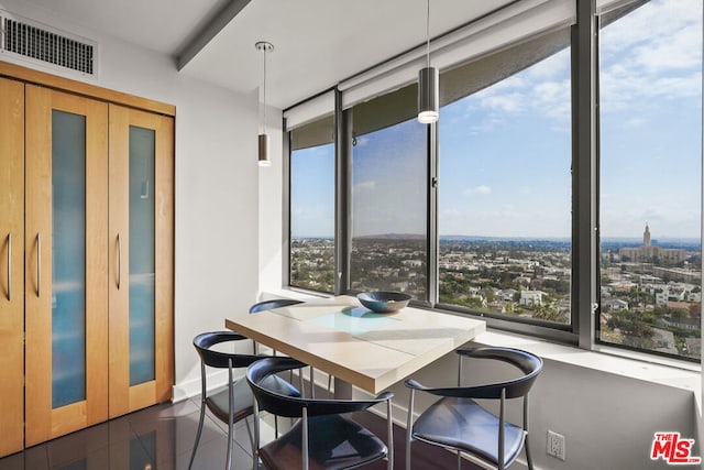 tiled dining room with a wall of windows and a healthy amount of sunlight