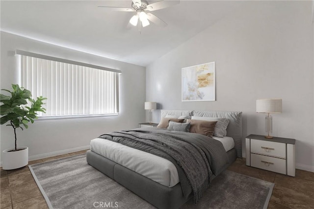 tiled bedroom featuring ceiling fan and vaulted ceiling