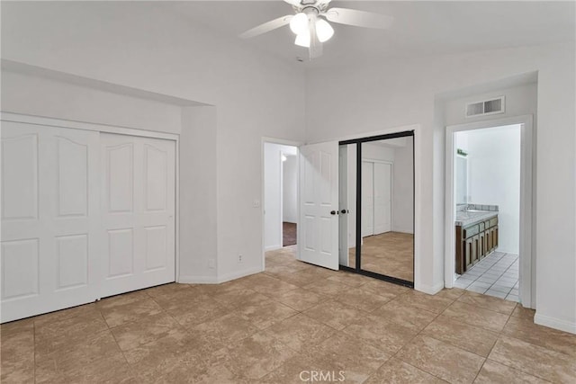 unfurnished bedroom featuring ceiling fan and connected bathroom