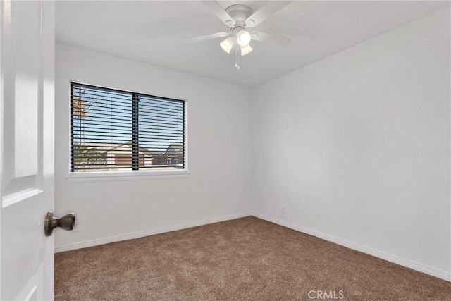 carpeted spare room featuring ceiling fan