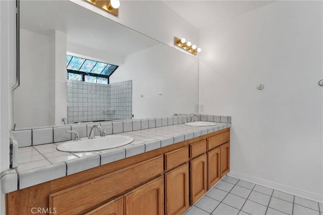 bathroom with vanity, tile patterned flooring, and a skylight