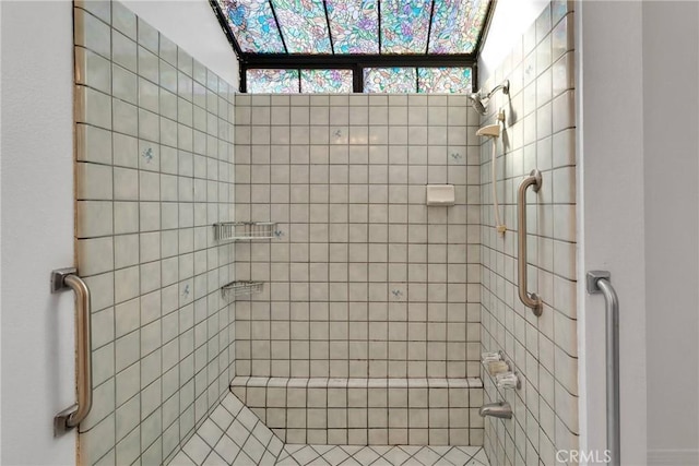 bathroom with a tile shower