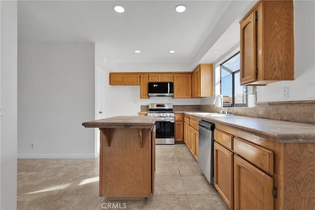 kitchen with sink, a center island, tile countertops, light tile patterned floors, and appliances with stainless steel finishes