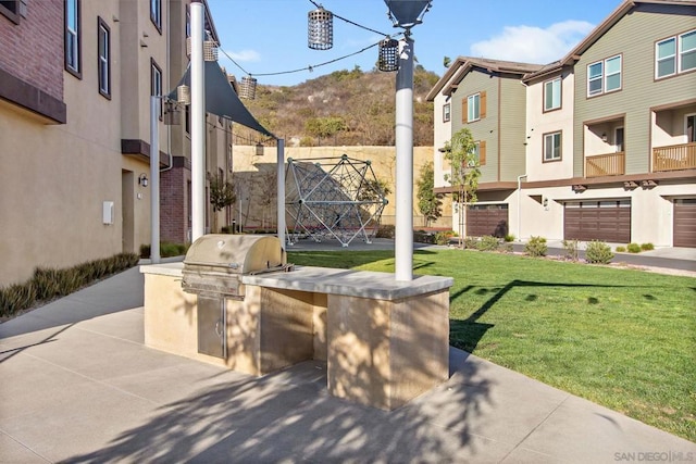 view of patio with exterior kitchen and grilling area