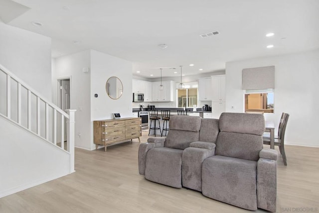 living room with light hardwood / wood-style flooring