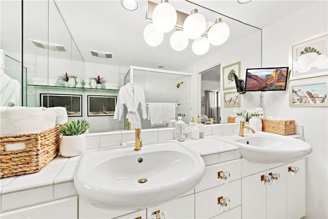 bathroom with a shower with door and vanity