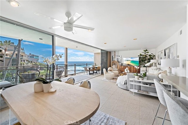 dining area with ceiling fan and expansive windows