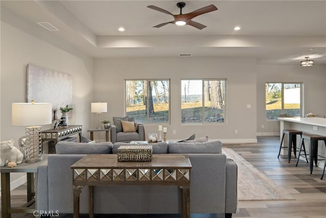 living room with hardwood / wood-style floors and ceiling fan