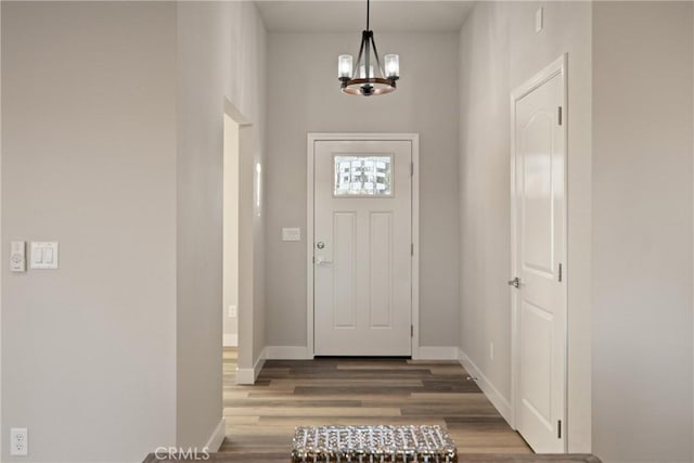 foyer with a notable chandelier and hardwood / wood-style floors