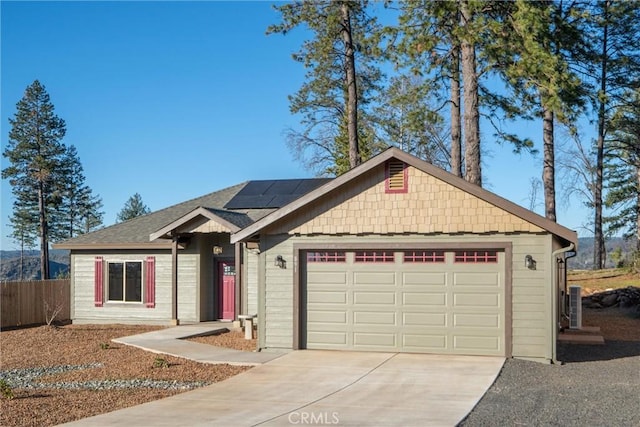 view of front of house with solar panels and a garage