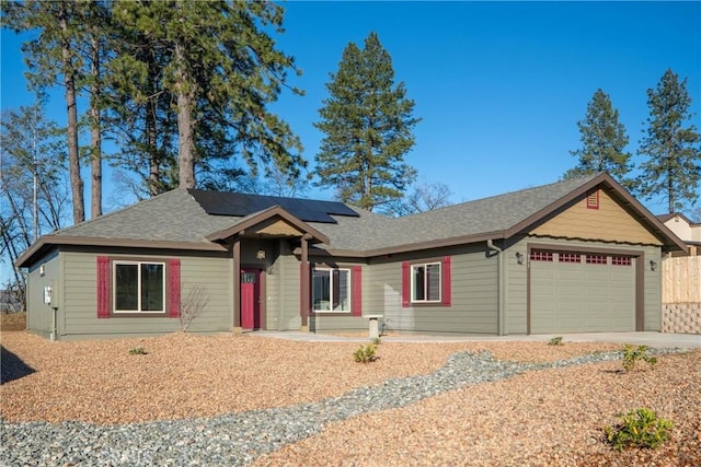 ranch-style house featuring solar panels and a garage