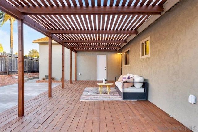 wooden terrace featuring a pergola and an outdoor living space