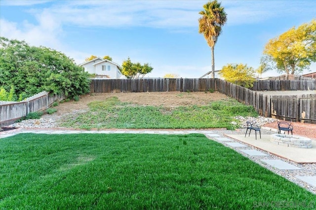 view of yard with a patio area and a fire pit