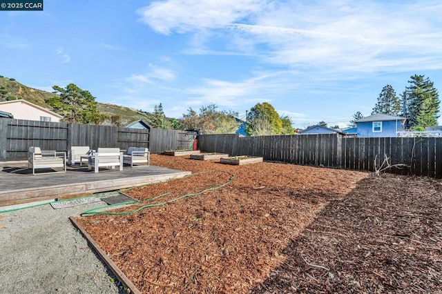 view of yard featuring a wooden deck and an outdoor hangout area