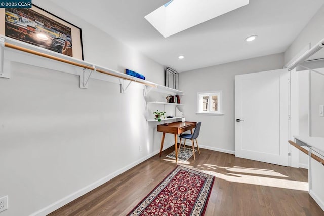 interior space featuring dark hardwood / wood-style floors and a skylight