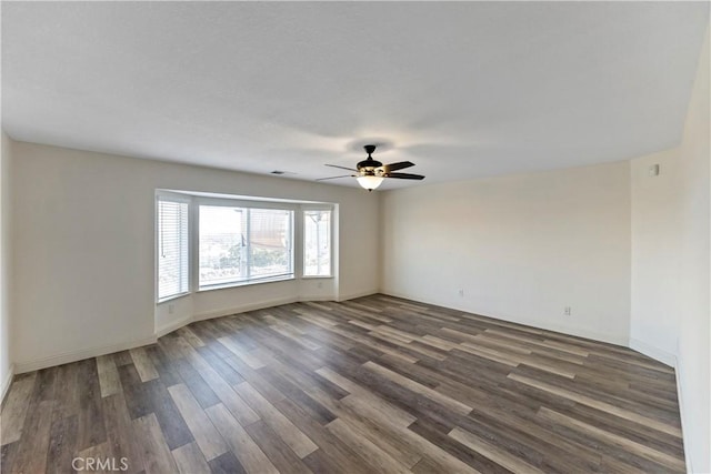 unfurnished room featuring ceiling fan and dark hardwood / wood-style floors