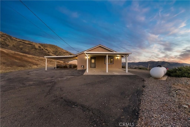 view of front facade with a carport and a mountain view