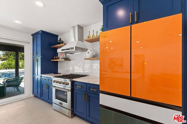 kitchen with gas range, refrigerator, exhaust hood, decorative backsplash, and blue cabinetry